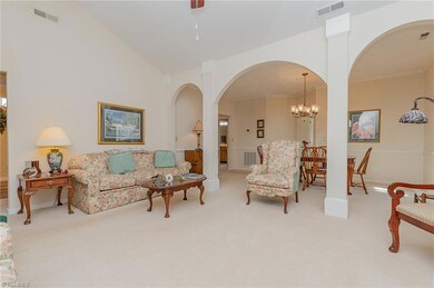 Living room connects to dining room and hallway to bedrooms.