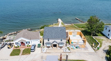 Aerial view of property and surrounding area featuring a nearby body of water