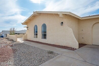 View of side of property featuring stucco siding