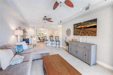 Living room with light tile patterned flooring and a ceiling fan