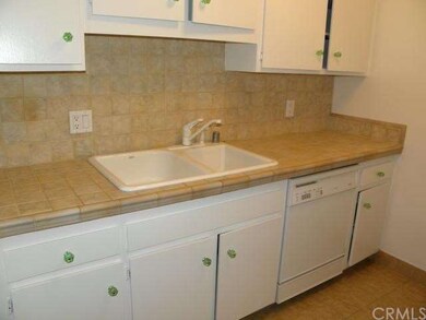 Kitchen has newer tile counters, fresh paint and i