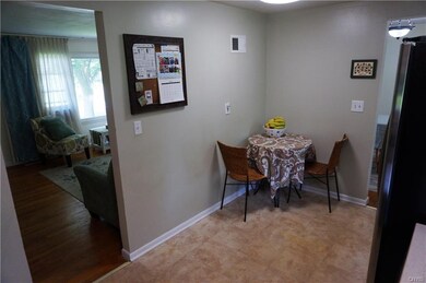 This view of the kitchen shows the eat-in area and