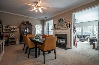 Dining area featuring crown molding, a fireplace w