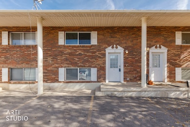View of front of home with brick siding and a porch
