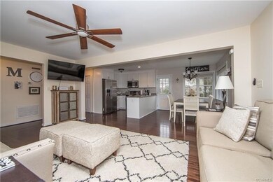 living room with hardwood floors, overhead fan, an