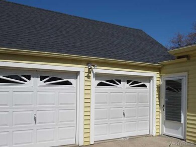 Exterior Front. Large garage with workshop and pri