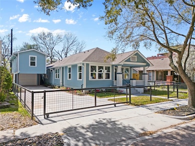 Gated front entry with a long driveway leading to