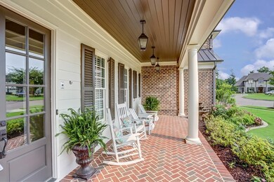 Charming covered front porch with detailed brick f
