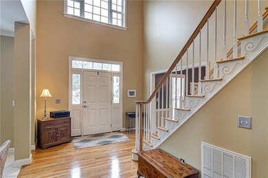 2 story entry with hardwood flooring.