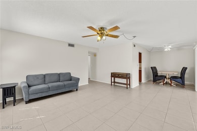 Living area featuring light tile patterned floors,