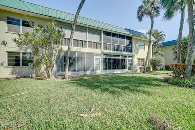 Back of house featuring a sunroom and a lawn