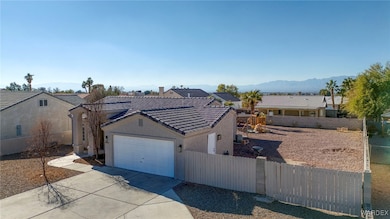 Ranch-style home with a garage and a mountain view