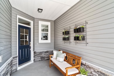 Doorway to property featuring stone siding