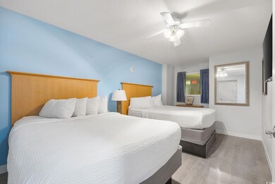 Bedroom featuring ceiling fan and light wood-type 