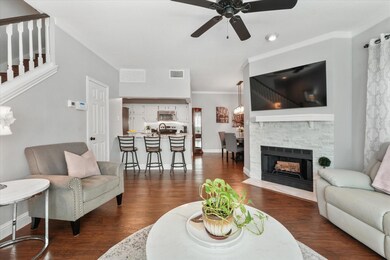 Living room featuring ceiling fan, a fireplace