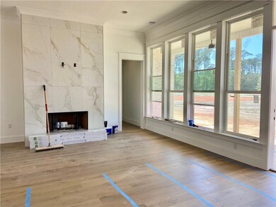 Den with center wall tiled fireplace