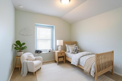 Bedroom featuring carpet flooring and vaulted ceiling