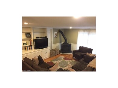 Cozy sunken family room with built-ins, woodburner