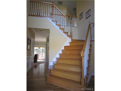 Elegant two-story entrance foyer with turning stai