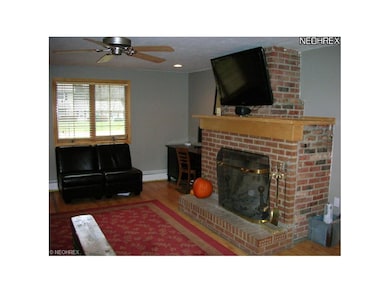 Family room with woodburning brick fireplace, ceil
