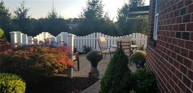 Fenced in patio with stone walkway