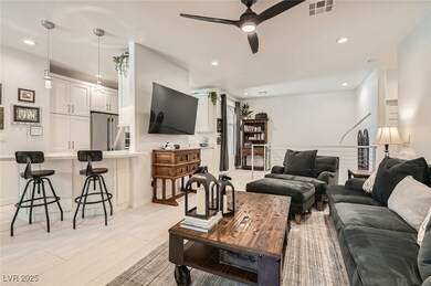 Living area with ceiling fan and recessed lighting
