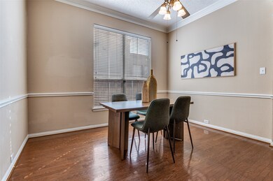 Office space featuring ornamental molding, dark wood-type flooring, ceiling fan, and a textured ceiling