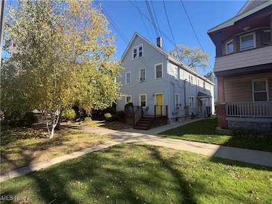 View of front of home featuring a chimney and a front lawn