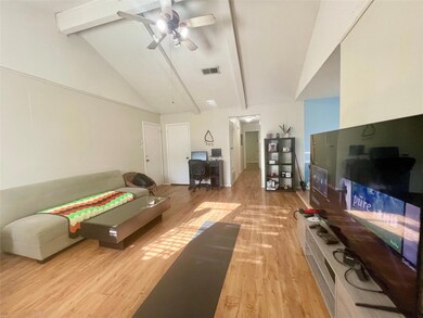 Living room with light wood-style flooring, beame