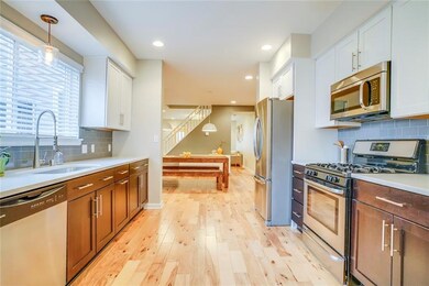 The kitchen offers numerous cabinets for storage. 