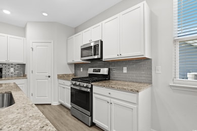 Kitchen featuring stainless steel appliances, ligh