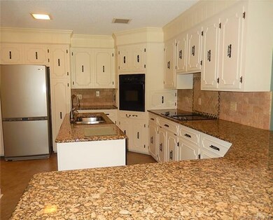 Cabinets galore!  Granite countertops, tile backsplash, wall oven, and island combine to make this a wonderful kitchen.