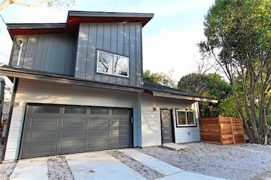 Contemporary house featuring fence, an attached g