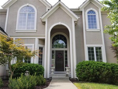 A GRAND ENTRANCE AND COVERED PORCH. BEAUTIFUL LAND