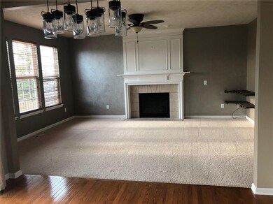 Great Room with fireplace that overlooks backyard and pond