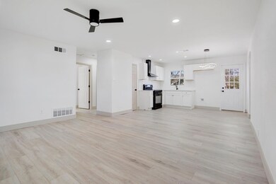 Unfurnished living room featuring a ceiling fan, r