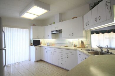 Many cabinets in this spacious Kitchen