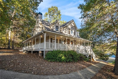 Farmhouse-style home featuring a porch and a chimney