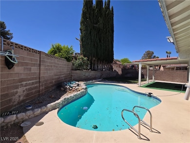 View of pool featuring a patio area, a fenced back