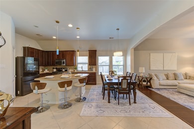 This open-concept kitchen, dining, and living area