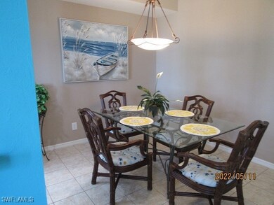 Dining area with baseboards and light tile pattern