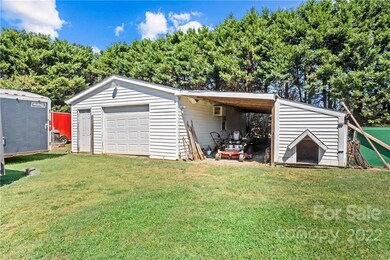 Backyard heated and cooled workshop along with a covered shed area