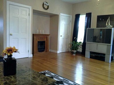 Living Room. Gleaming hardwood floors compliment t