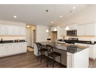 Photo shows model home kitchen - Powell floor plan