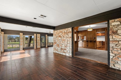 Unfurnished room featuring beam ceiling, wood fin
