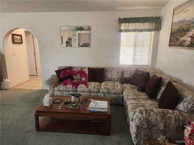 Carpeted living room with natural light