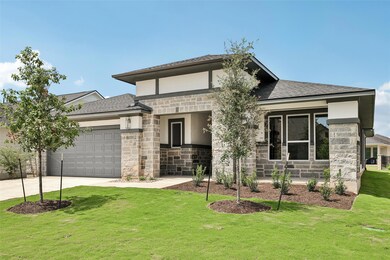 Prairie-style home featuring driveway, roof with 