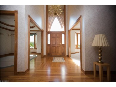 Elegant foyer is flanked by living room and dining
