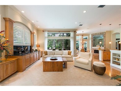 Spacious family room features wet bar and custom c