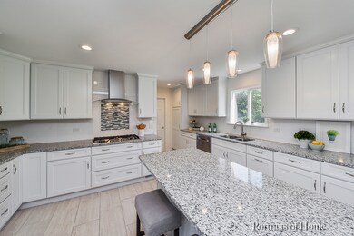 Modern lighting pendants over island and eat-in ar